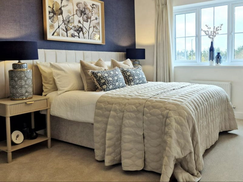 show home master bedroom in neutrals and dusky blue