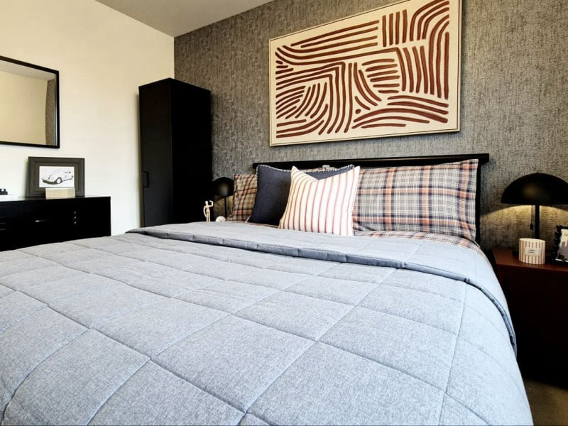 masculine show home bedroom in blues blacks and reds