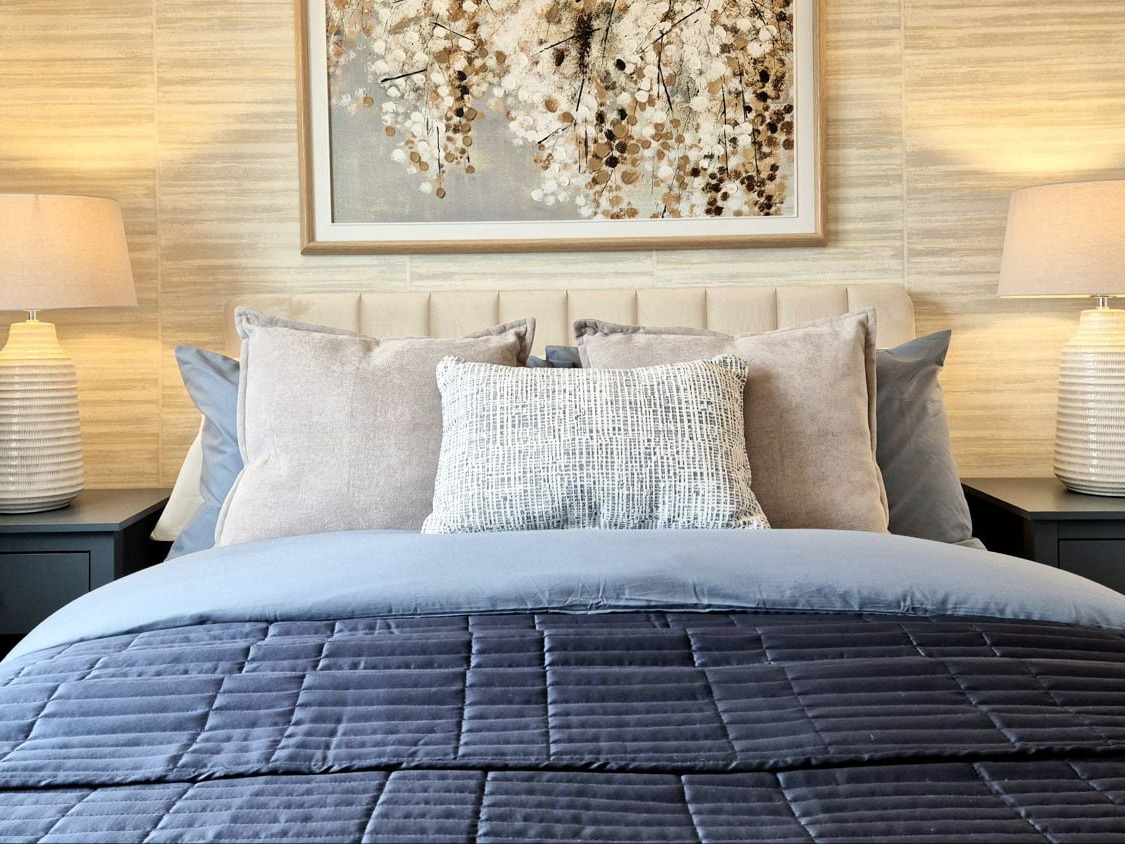 show home guest bedroom in neutrals and dusky blues